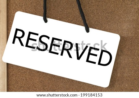 Reserved sign label on wooden board.