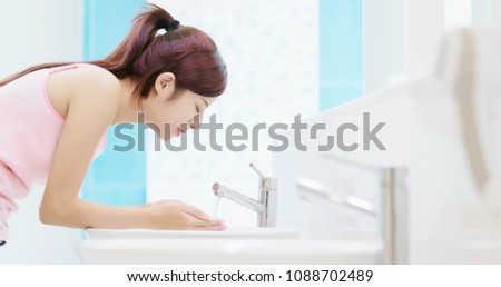 woman wash her face in the bathroom