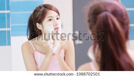 woman wash her face in the bathroom