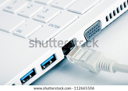 Internet Network cables are connected to computer. Shallow depth-of-field.