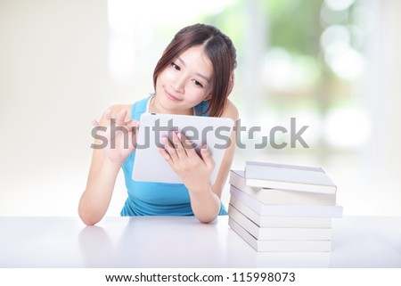 Young student girl smile using tablet pc at the desk with green background model is a asian woman Young student girl smile using tablet pc at the desk with green background model is a asian woman