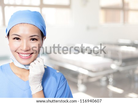 Medical person: Nurse / young doctor portrait. Confident young woman medical professional in hospital. Young pretty Asian female model.