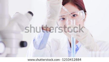 woman scientist take test tube in the laboratory