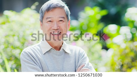 old man smile to you with nature green background