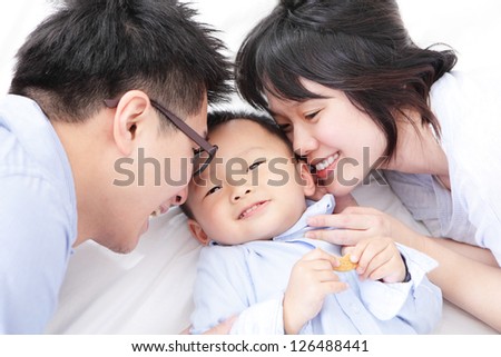 Happy family with children in bed, asian people