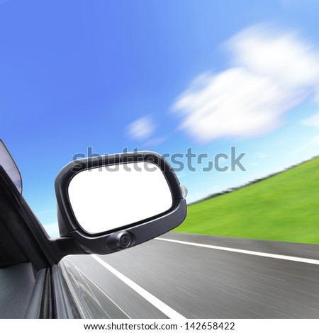 car and rear view mirror on the road