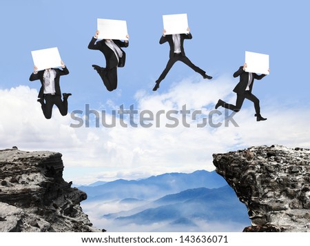 businessman jumping with empty billboard and over danger precipice on the mountain, concept for business, asian people