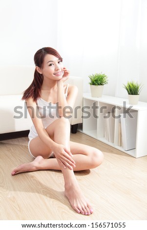 Beautiful skin care young woman happy hand touch her skin of face at home, asian beauty