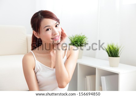 Beautiful skin care young woman happy hand touch her skin of face at home, asian beauty