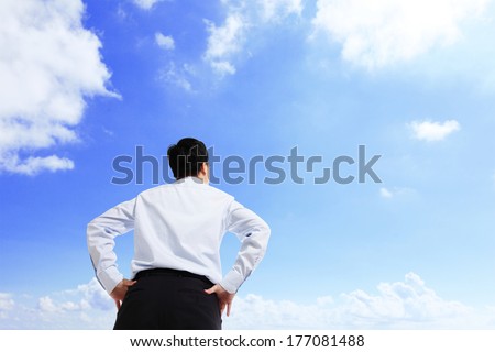 Business man watching the sky with copy space