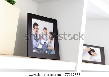 Happy Family photo on white bookshelf at home