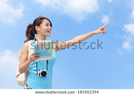 Happy women traveler pointing copy space with map in the sky