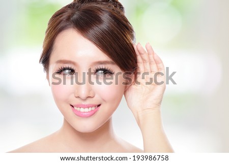 attractive woman with health skin and teeth, she is happy hear to you with nature green background, asian