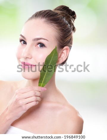 Skin care woman face with green leaf, concept for skin care or organic cosmetics, caucasian