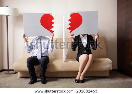 Divorce - Sad young couple holding billboard sign with break love heart, concept for divorce