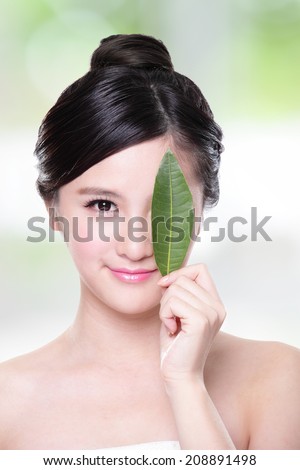 beautiful woman face portrait with green leaf , concept for skin care or organic cosmetics , asian beauty