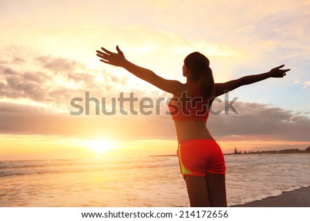 Smile Freedom and carefree sport woman on beach. She is enjoying serene ocean nature during sport outdoors. asian beauty