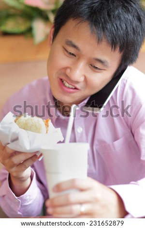 business man having lunch and eat fast food in a restaurant, asian