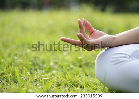 close up of Yoga woman hand in lotus pose. Girl practicing yoga outdoors