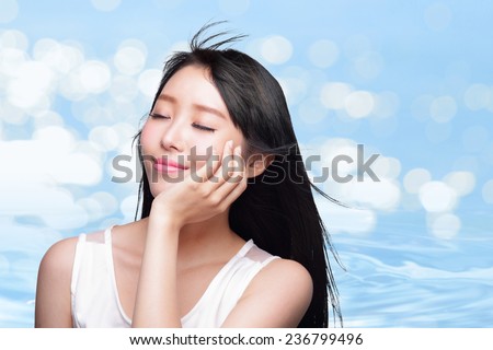 Beauty Skin care concept, Beautiful woman face and long hair with Water splashes blue background, asian beauty