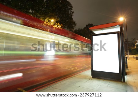 Blank billboard in bus stop at night with the lights of the cars passing by, great copy space for your design, shot in London, United Kingdom, uk