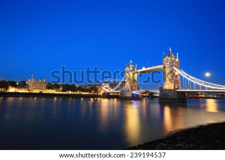 Tower Bridge and The Tower of London with reflections in the thames river at sunset in London, United Kingdom, England