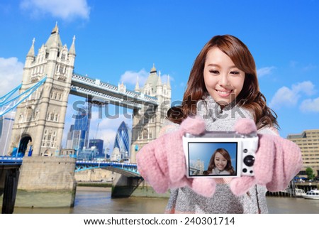Happy woman tourist travel in london and photo selfie by camera with Tower Bridge in United Kingdom, uk