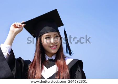 happy graduate student girl look up to copy space and feel carefree, she wear graduation cap and gown ,asian