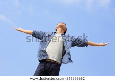 Carefree and free man raised hands and looking to a sky, asian