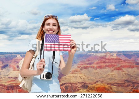 Happy Woman mountain Hiker or traveler holding America flag with backpack enjoy view in grand canyon