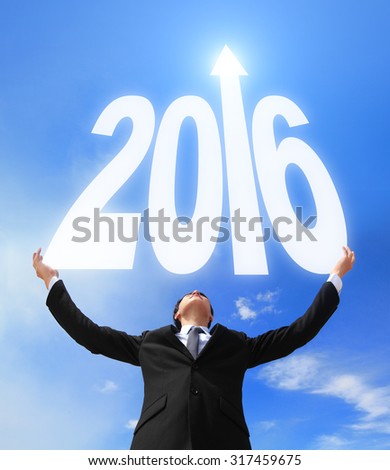 Happy new year - Business man holding 2016 new year imagination with sky and cloud, asian