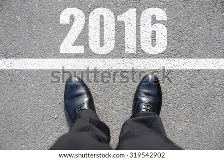 Start to new year 2016 - top view of business man walking on the road