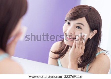 Close up of Smile woman remove makeup by Cleansing Cotton and look mirror. asian beauty
