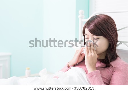 Sick Woman sneezing into Tissue. Flu and Woman Caught Cold.
