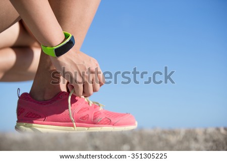 Health sport woman wearing smart watch device with touchscreen doing exercises