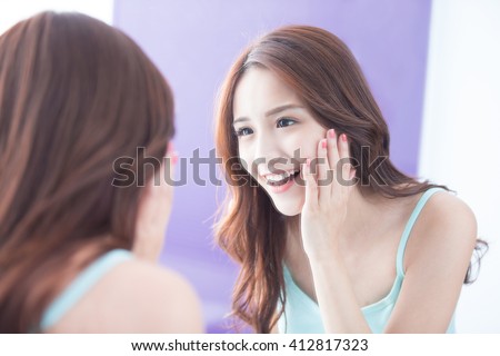 Beautiful skin care woman smile and look mirror. asian beauty