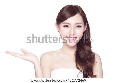 Beauty woman show something to you with charming smile, health skin, teeth and hair isolated on white background, asian beauty