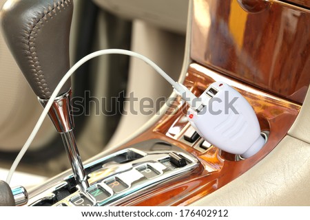 USB adapter converter plug with charging cable on a car