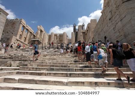 ATHENS, GREECE - JUNE 26: Tourists in famous old city Acropolis on June 26, 2011 in Athens, Greece. Its construction began in 447 BC in the Athenian Empire. It was completed in 438 BC