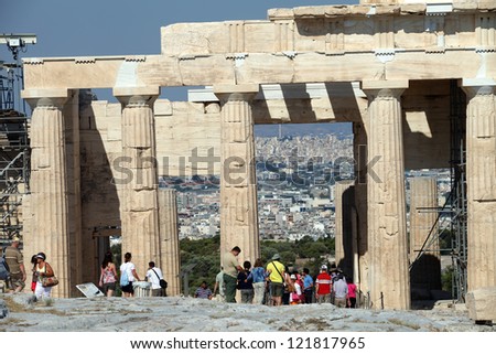 ATHENS, GREECE - JUNE 29: Tourists in famous old city Acropolis on June 29, 2012 in Athens, Greece. Construction began in 447 BC in the Athenian Empire. It was completed in 438 BC.