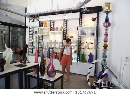 ISTANBUL, TURKEY - AUGUST 8: A woman looking at glass work in the Glass Museum on August 8, 2012 in Istanbul, Turkey.