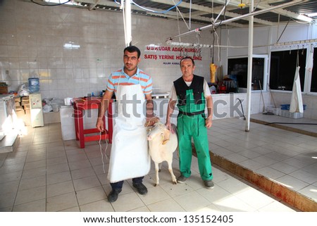 ISTANBUL, TURKEY - OCTOBER 16: Butchers in the meat cutting room before feast of the sacrifice on October 16, 2012 in Istanbul, Turkey.