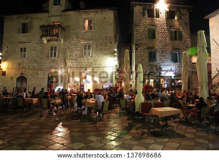 KOTOR, MONTENEGRO - SEPTEMBER 6: People resting at restaurants in Kotor Old Town Square at night on September 6, 2012 in Kotor, Montenegro. Kotor is part of the UNESCO World Heritage Site.