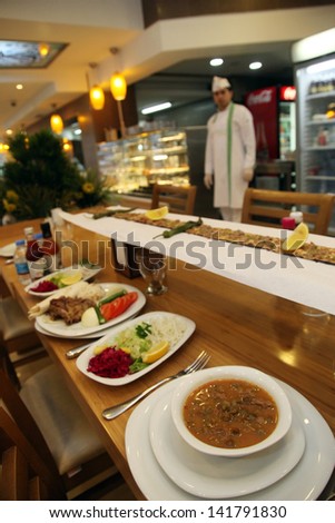 ISTANBUL, TURKEY - FEBRUARY 14: Turkish chicken kebab, Okra soup (Gumbo), lahmacun, salad and dessert in the famous Turkish restaurant \'Ovali\' on February 14, 2012 in Istanbul, Turkey.