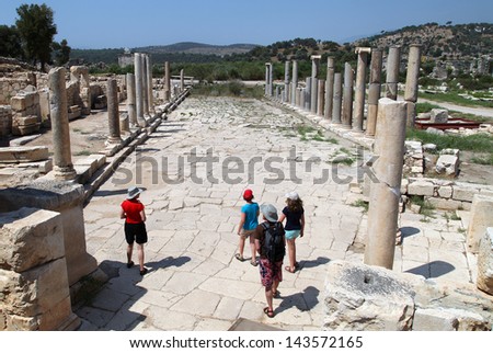ANTALYA, TURKEY - JUNE 25: Tourists at colonnade street and ruins on June 25, 2012 in Antalya, Turkey. Patara is ancient city in Antalya.