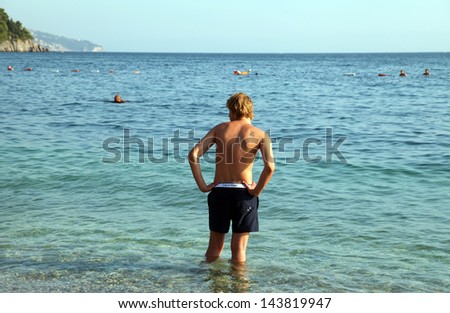 BUDVA, MONTENEGRO - SEPTEMBER 8: A man swimming at Budva Beach on September 8, 2012 in Budva, Montenegro. Budva among the oldest urban settlements of the Adriatic coast.