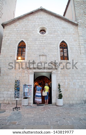 BUDVA, MONTENEGRO - SEPTEMBER 8: People praying in Holly Trinity Church at Budva Old Town Center in Budva, Montenegro.on September 8, 2012 in Budva, Montenegro.