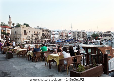 KYRENIA, NORTH CYPRUS - JUNE 17: People resting restaurant in Kyrenia (Girne) Marina on June 17, 2011 in Kyrenia, North Cyprus. Kyrenia harbor is currently a tourist resort.