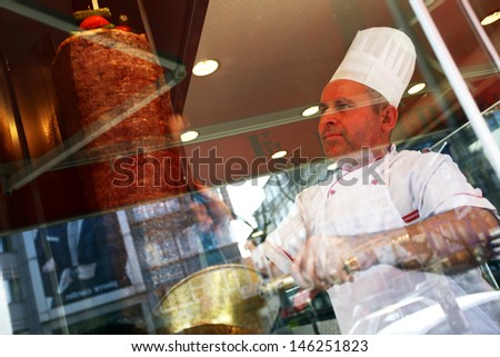 ISTANBUL, TURKEY - JUNE 14: A chef cutting traditional Turkish food Doner Kebab in the restaurant on June 14, 2011 in Istanbul, Turkey.