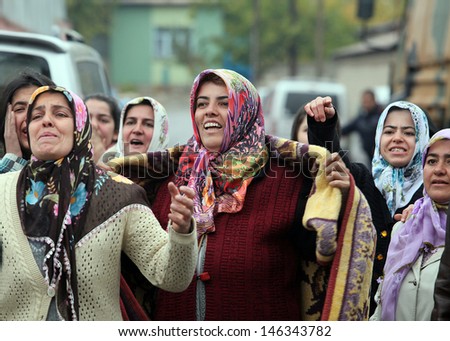 VAN, TURKEY - OCTOBER 25: Turkish women crying and praying in front of our house on October 25, 2011 in Van, Turkey. It is 604 killed and 4152 injured in Van Earthquake.